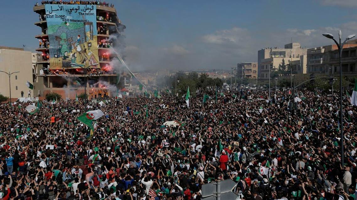Demonstrators light flares during a protest in Bordj Bou Arreridj, east of Algiers, Friday, April 26, 2019. Algerians are massing for a 10th week of protests against their country’s ruling class, calling for the ex-president’s brother to be put on trial. (AP)