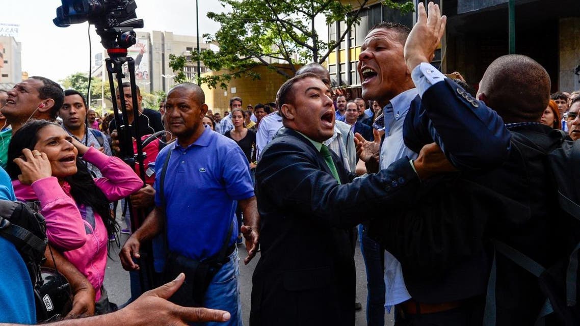A file photo of Gilber Caro (2-R) argues with supporters of Venezuelan president Nicolas Maduro during a demonstration in Caracas. (AFP)