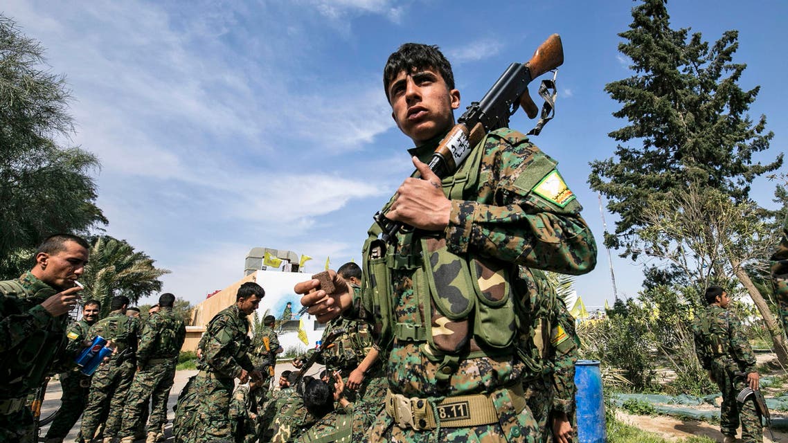 Fighters of the US-backed Kurdish-led Syrian Democratic Forces (SDF) celebrate near the Omar oil field in the eastern Syrian Deir Ezzor province on March 23, 2019, after announcing the total elimination of the Islamic St (AFP)
