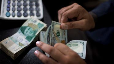 A Pakistani money changer counts US dollar bills in Islamabad, Pakistan, Friday, Nov. 30, 2018. (AP)