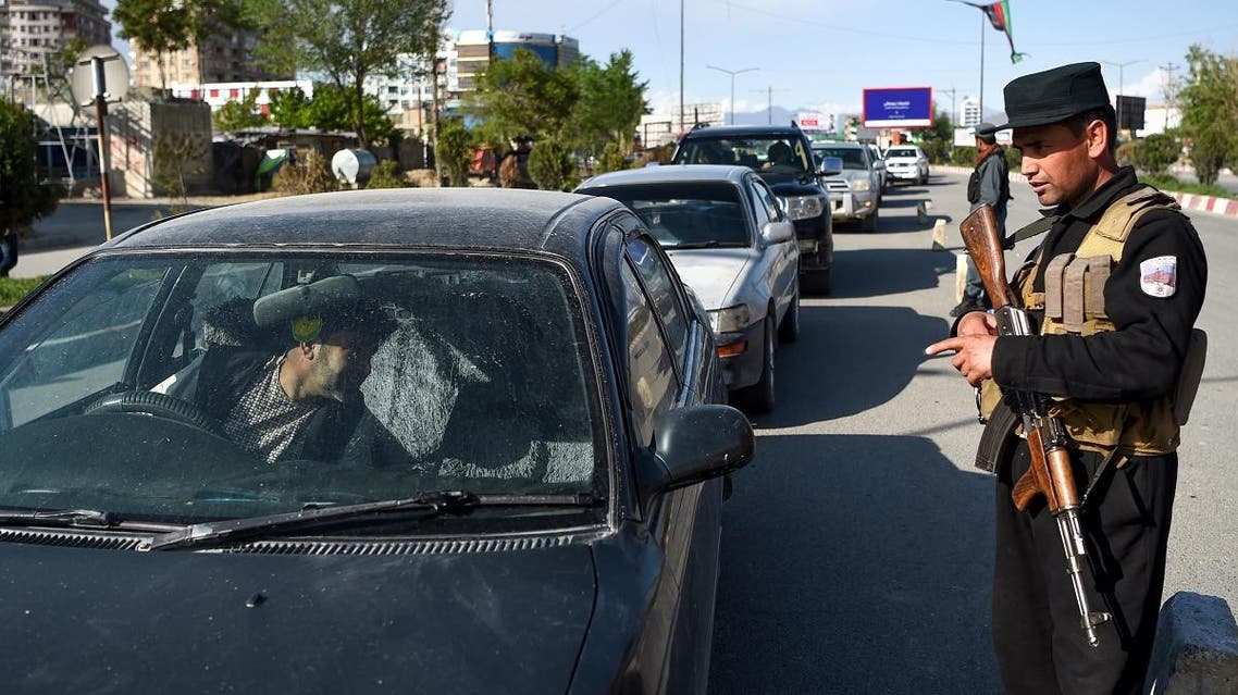 An Afghan policeman stops passengers at a checkpoint in the city in Kabul on April 30, 2019. (AFP)