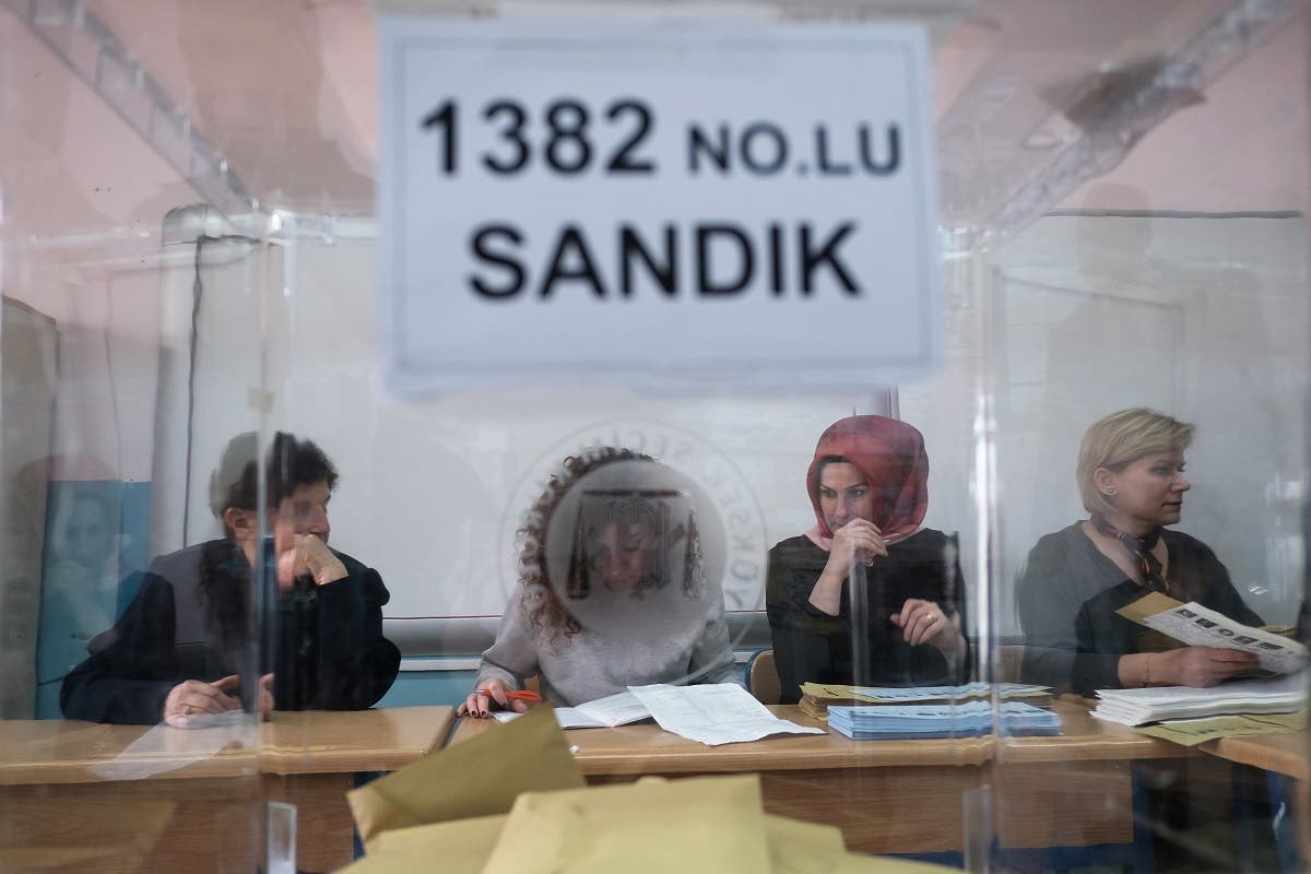 Election officials are seen through a ballot box work at a polling station during local elections in Istanbul. (File photo: AFP)