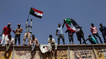 Sudanese protesters wave national flags at the sit-in outside the military headquarters, in Khartoum on May 2, 2019. (AP)