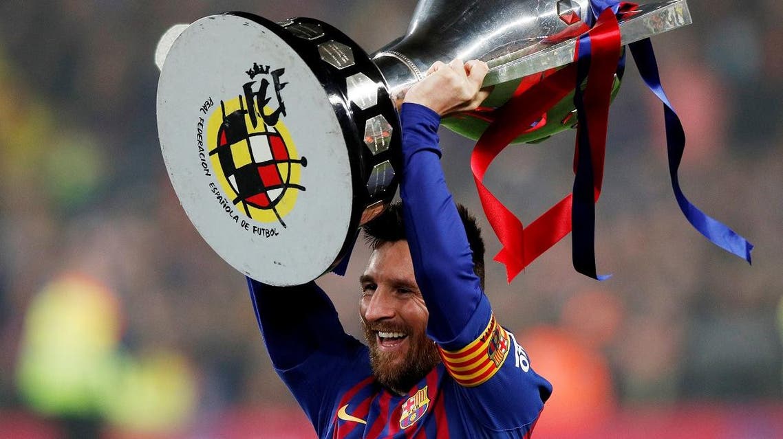 Barcelona’s Lionel Messi celebrates winning La Liga with the trophy at Camp Nou, Barcelona, on April 27, 2019. (Reuters)