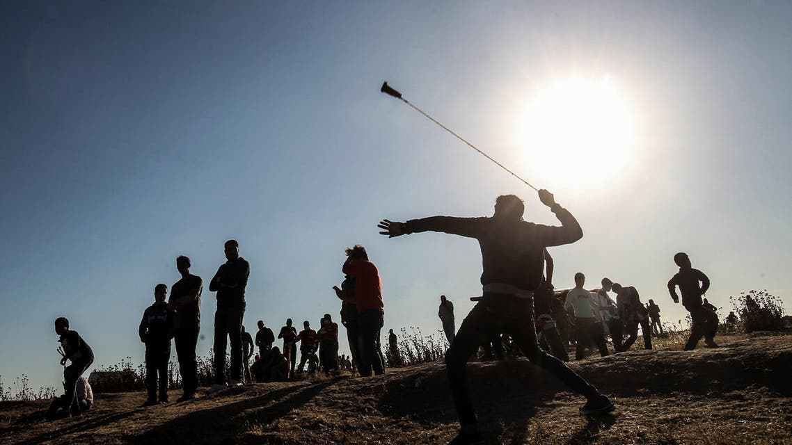 A Palestinian protester hurls stones at Israeli troops during a demonstration near the border with Israel, east of Gaza City, on May 10, 2019. (AFP)