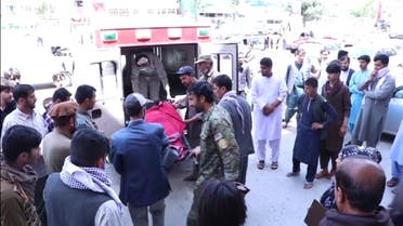 Men putting body bag containing dead ex-journalist into ambulance outside Kabul hospital. (Photo courtesy: Radio Free Europe via Reuters)
