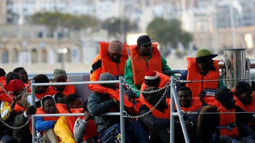 Migrants who were stranded on the German NGO Sea-Eye migrant rescue ship Alan Kurdi are seen before disembarking from an Armed Forces of Malta patrol boat at its base in Marsamxett Harbour, Valletta, Malta (Reuters)