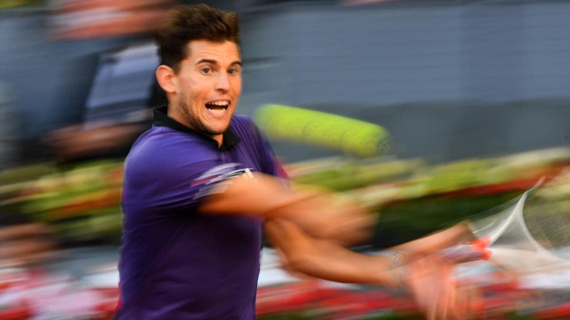 Dominic Thiem returns the ball to Roger Federer during their ATP Madrid Open quarter-final tennis match at the Caja Magica in Madrid on May 10, 2019. (AFP)