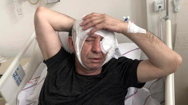 Yavuz Selim Demirag, a Turkish journalist critical of President Recep Tayyip Erdogan's government, rests in a hospital bed in Ankara. (AP)