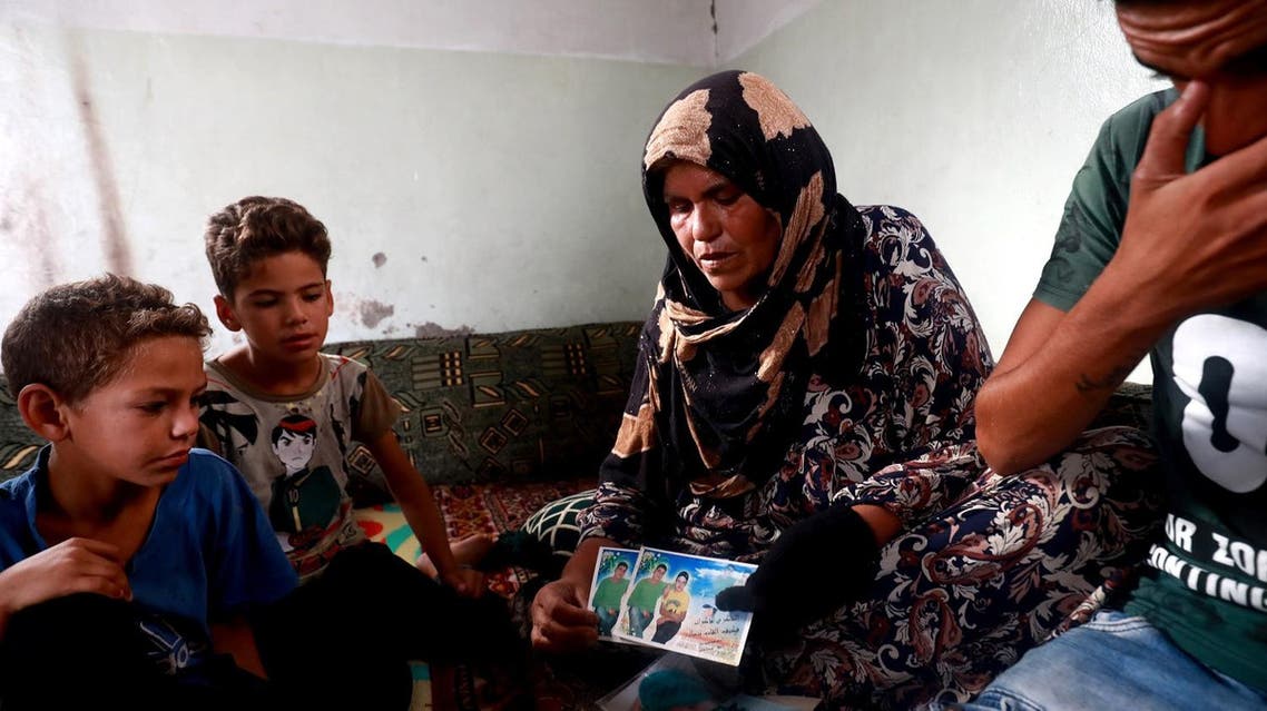 Zarifa Mahmoud Nazzal shows pictures as she speaks of her search for her missing son, Moussa, who was captured three years ago by the Islamic State group in Raqa, on October 14, 2018.