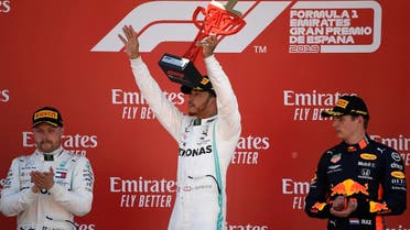 Mercedes’ driver Lewis Hamilton (C), first placed, Mercedes’ driver Valtteri Bottas (L), second placed, and Red Bull’s driver Max Verstappen, third placed, celebrate on the podium of the Spanish Formula One Grand Prix on May 12, 2019. (AFP)