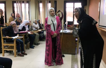 Students perform a skit at Cairo University as part of a new government project aimed at curbing Egypt's divorce rate, in Cairo, Egyp. (Reuters)