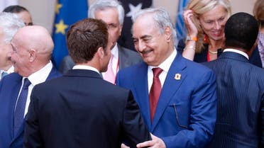 Field Marshal Khalifa Haftar shakes hands with French President Emmanuel Macron at the International Conference on Libya in May 2018. (File photo: AFP)