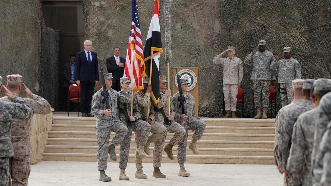 The US flag, Iraq flag, and the US Forces Iraq colors are seen before they are carried in during ceremonies marking the end of US military mission in Baghdad, Iraq, Thursday, Dec. 15, 2011. (AP)