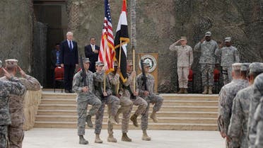 The US flag, Iraq flag, and the US Forces Iraq colors are seen before they are carried in during ceremonies marking the end of US military mission in Baghdad, Iraq, Thursday, Dec. 15, 2011. (AP)