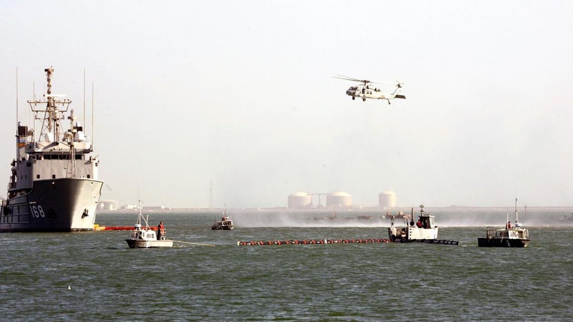 A US Navy Ocean Tug ship and helicopter of the Bahrain-based Fifth Fleet particpates in a crisis response exercise in a port in the capital Manama. (File photo: AFP)