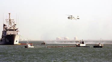 A US Navy Ocean Tug ship and helicopter of the Bahrain-based Fifth Fleet particpates in a crisis response exercise in a port in the capital Manama. (File photo: AFP)