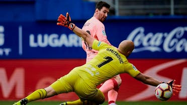 Barcelona’s Messi shoots to score in front Eibar’s goalkeeper Marko Dmitrovic during a Spanish La Liga match in Eibar, northern Spain, Sunday, May 19, 2019. (AP)
