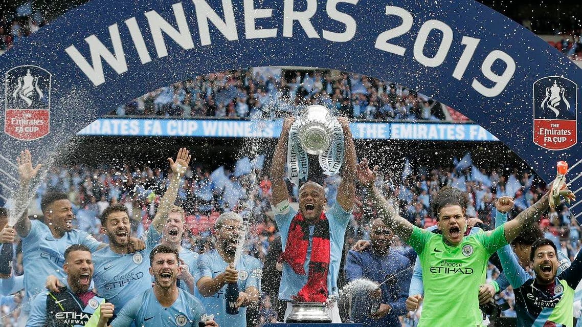 Manchester City players celebrate after winning the English FA Cup Final soccer match between Manchester City and Watford at Wembley stadium in London, on May 18, 2019.