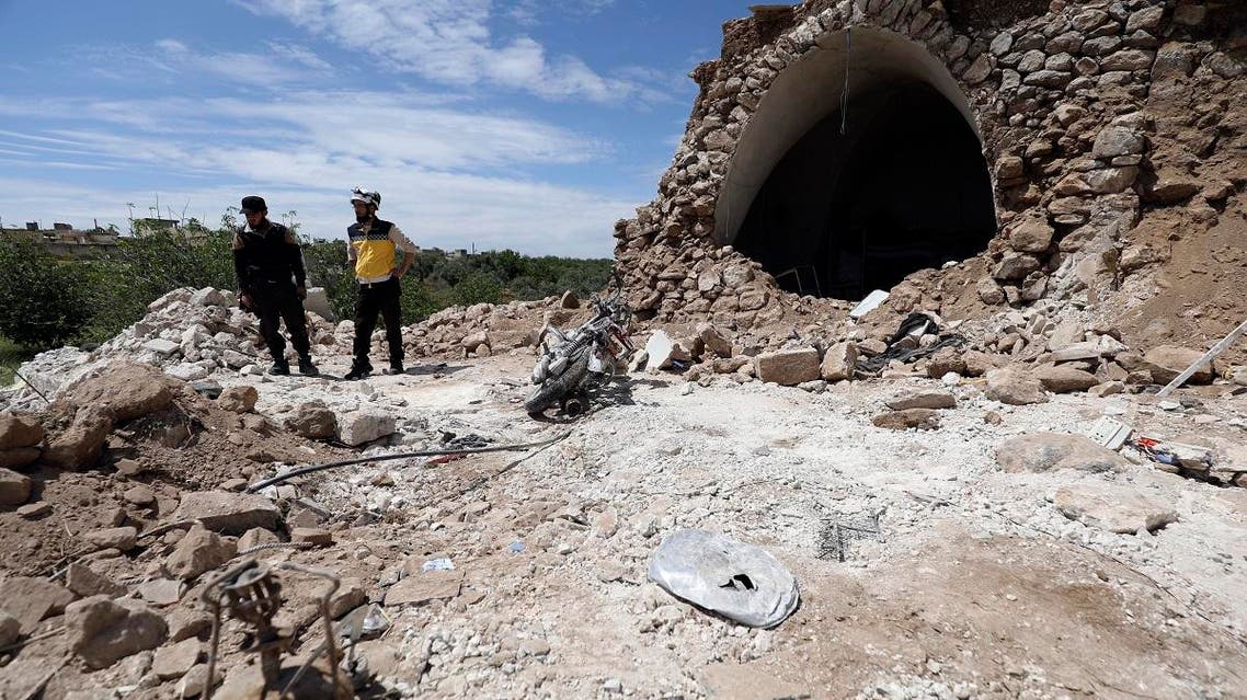 A member of the Syrian Civil Defence (White Helmets) inspects the rubble following shelling by Syrian regime forces on the village of Maarit Sin in the countryside of the rebel-held Idlib province. (AFP)