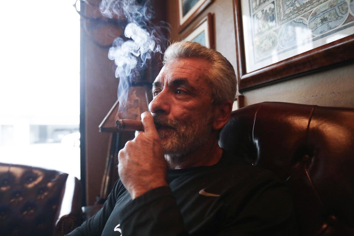 Owner Rigo Fernandez poses for photos smoking a cigar in his Buena Vista Cigar Club on May 10, 2019 in Beverly Hills, California. (AFP)