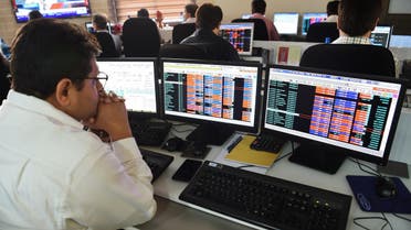 An Indian stock trader looks at share prices during intra-day trade at a brokerage house in Mumbai on February 6, 2018. (File photo: AFP)