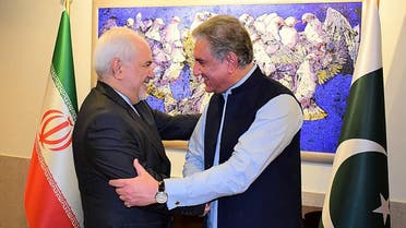Pakistan's Foreign Minister Shah Mehmood Qureshi (R) greets his Iranian counterpart Mohammad Javad Zarif at the Foreign Ministry in Islamabad on May 24, 2019. (AFP).
