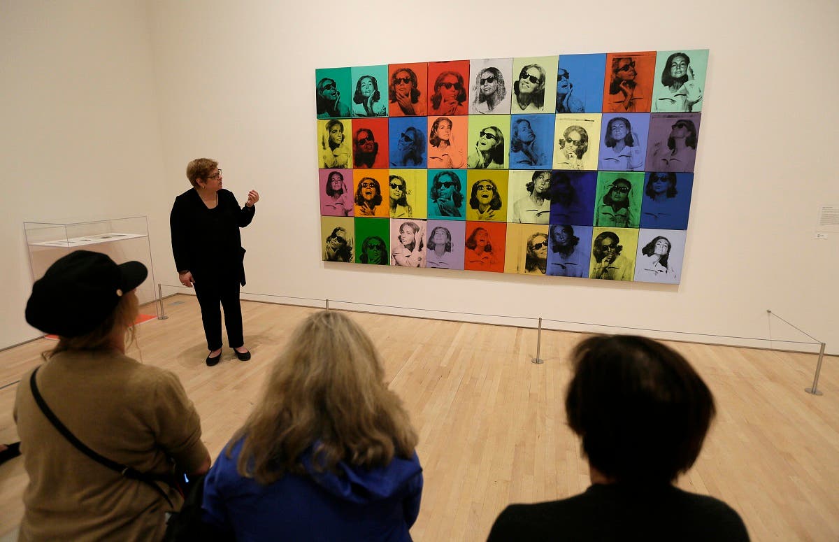 Donna DeSalvo, deputy director and senior curator at New York’s Whitney Museum of American Art, talks about the piece “Ethel Scull 36 Times” displayed in the exhibition “Andy Warhol - From A to B and Back Again,” in San Francisco. (AP)