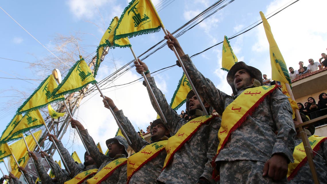 Members of Lebanon's Shiite Hezbollah movement stand at attention during the funeral of a fighter, who was killed in conflict against militant groups in the mountainous area around the Lebanese town of Arsal on the eastern border with war-ravaged Syria, in the southern town of Bisariyeh on August 28, 2017.