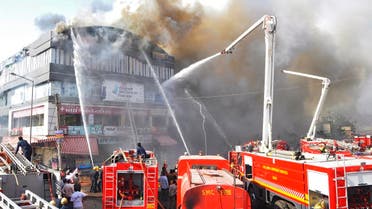Indian firefighters try to control a major fire in a building housing a college, in Surat, some 270 kms. from Ahmedabad on May 24, 2019. (AFP)