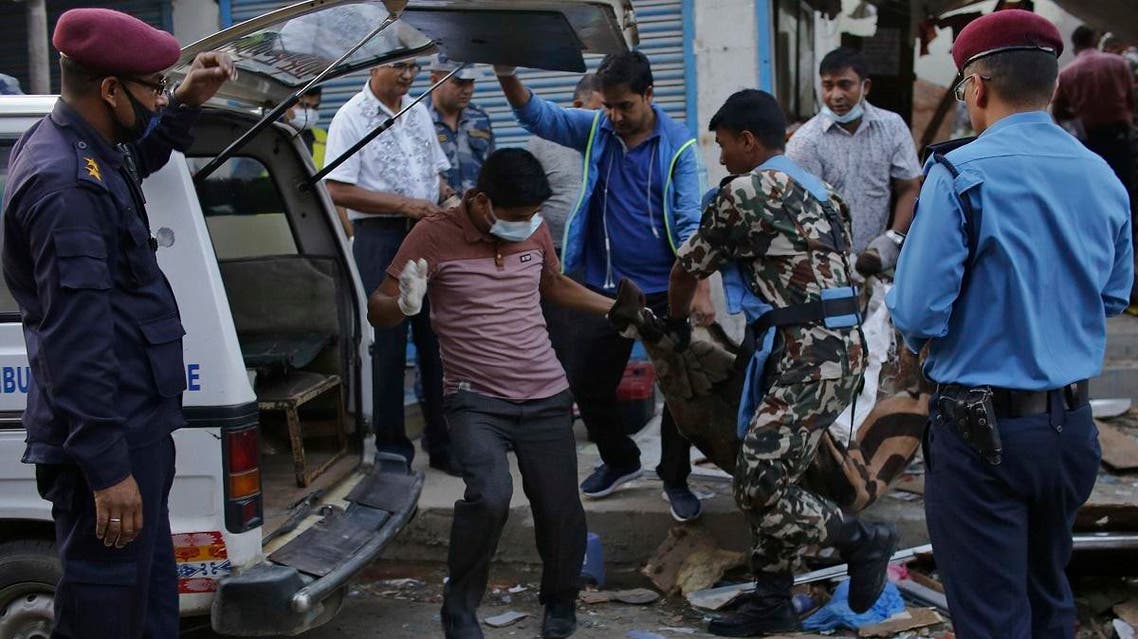The body of a victim is removed from the site of an explosion in Kathmandu, Nepal, Sunday, May 26, 2019. (AP)