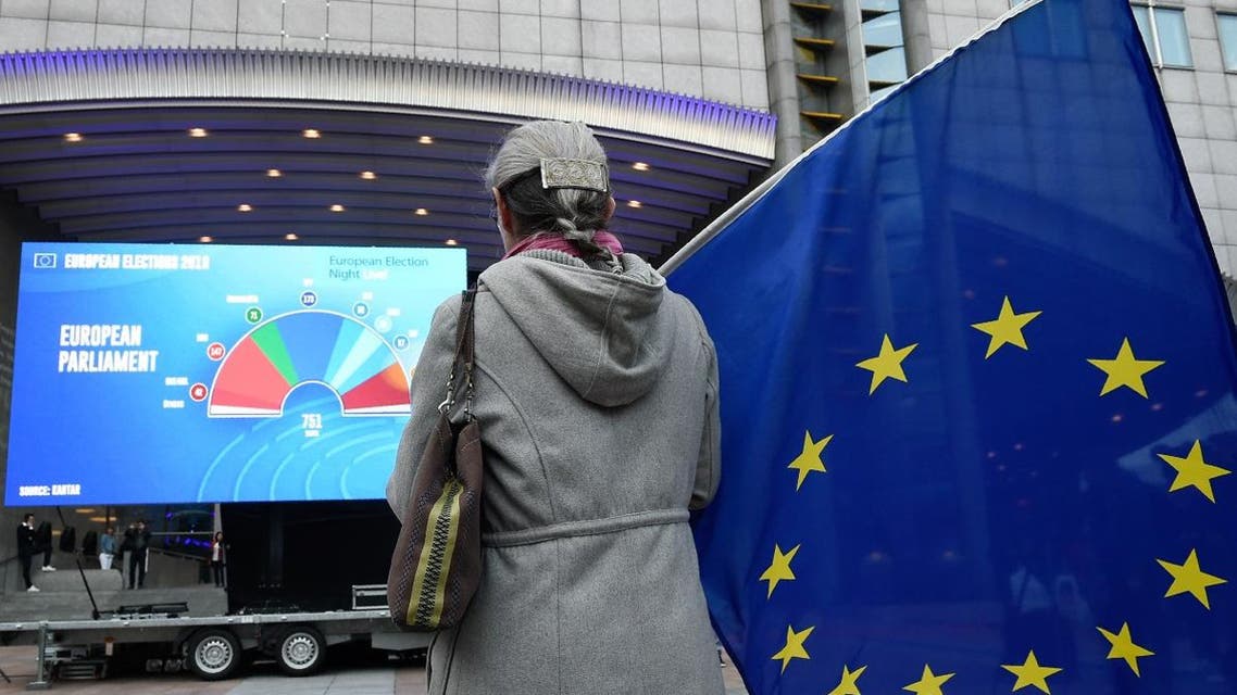 A woman holds an European flag outside the European Parliament as people wait for the European elections results in Brussels on May 26, 2019. (AFP)
