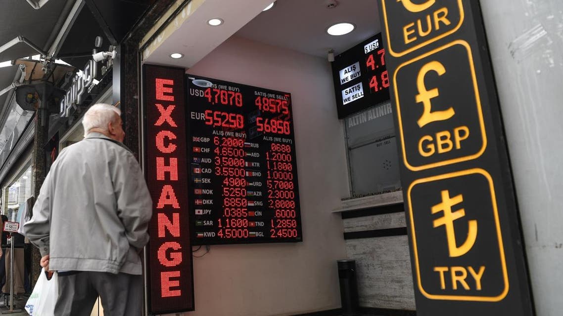A man looks to a board displaying US dollars and Euros exchange rates in Turkish liras on May 23, 2018 at a exchange office in Istanbul. (AFP)