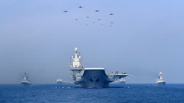 FILE PHOTO - Warships and fighter jets of the Chinese People's Liberation Army (PLA) Navy take part in a military display in the South China Sea April 12, 2018. To match Special Report CHINA-ARMY/NAVY REUTERS/Stringer/File Photo ATTENTION EDITORS - THIS IMAGE WAS PROVIDED BY A THIRD PARTY. CHINA OUT.