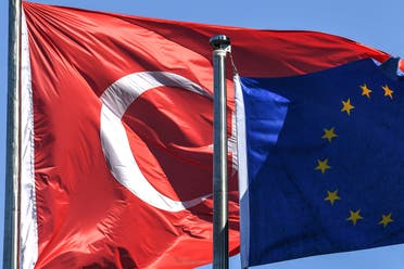 Turkish flag and European Union’s flag float in the wind at the financial and business district Maslak on August 15, 2018 in Istanbul. (AFP)