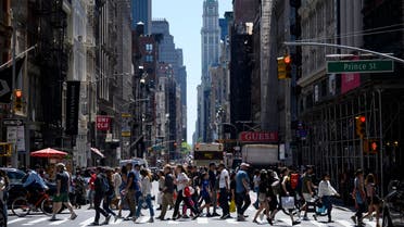People pass Broadway on a sunny day May 18, 2019 in New York City. (AFP)