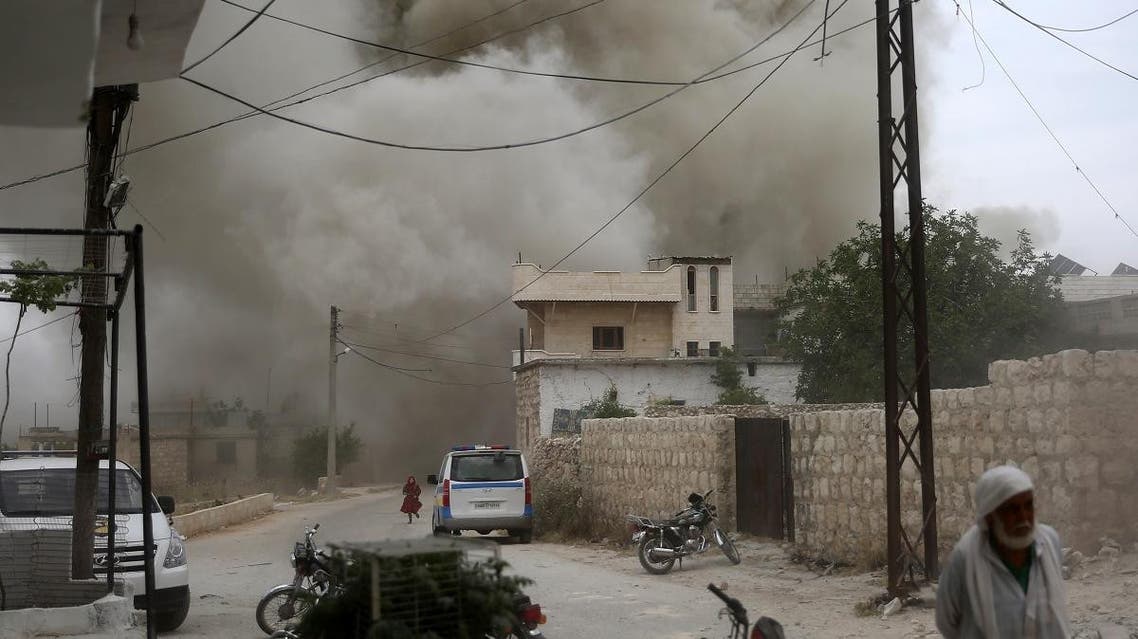 Syrians run for cover during an air strike by pro-regime forces on the market town of Kfar Ruma in Syria’s southwestern Idlib province, on May 30, 2019. (AFP)