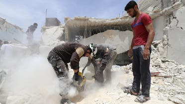 Syrian rescue teams search for survivors amid the rubble in a freshly bombarded area following a reported air strike by regime forces and their allies on the market town of Kfar Ruma in Syria's southwestern Idlib province, on May 30, 2019. (AFP)