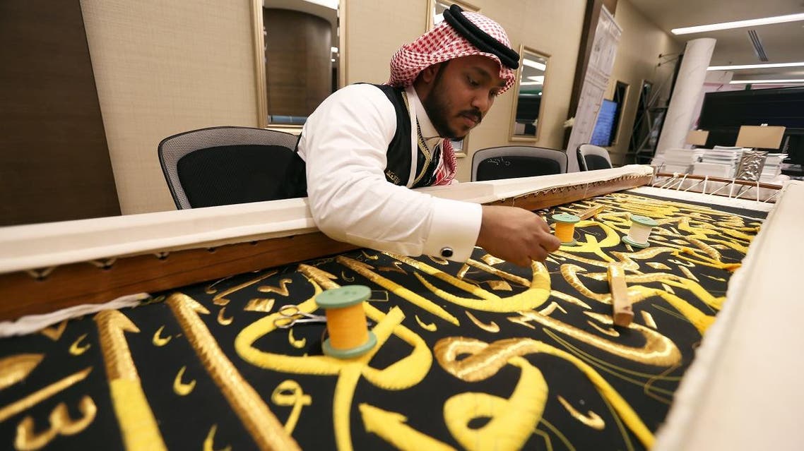 An Islamic calligrapher prepares one of the 36 pieces of the cover of the Holy Kaaba for the year 2020, at the Media Center for the 14th Islamic Summit in Mecca, Saudi Arabia, on May 30, 2019. (Reuters)