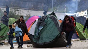 Migrant couple drag their tent, in the vicinity of Maljevac border crossing near Northern-Bosnian town of Velika Kladusa, on October 24, 2018. (AFP)