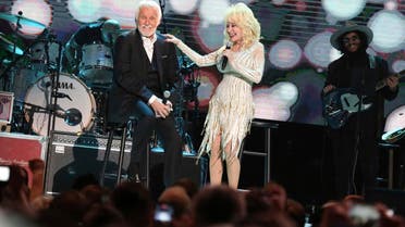 Kenny Rogers (left), and Dolly Parton share a few stories at “All In For The Gambler: Kenny Rogers’ Farewell Concert Celebration” at Bridgestone Arena on Oct. 25, 2017, in Nashville, Tennessee. (AP)