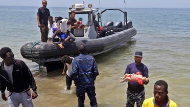 File photo of members of the Libyan security forces carry the bodies of babies as migrants who survived the sinking of an inflatable dinghy boat off of the coast of Libya. (AFP)