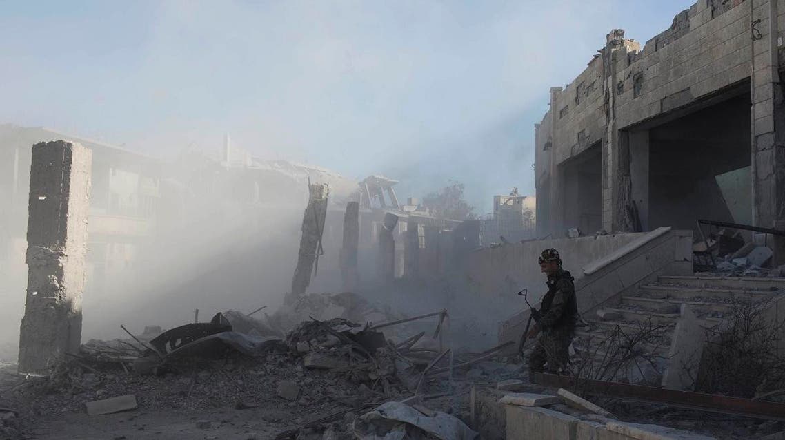 File photo of a member of the Syrian Democratic Forces (SDF) defusing a bomb left by ISIS militants at the stadium in the city of Raqqa, Syria. (AP)