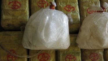 In this Feb. 15, 2013 photo, two bags of crystal meth and packets of methamphetamine pills trafficked from Myanmar are displayed at a press conference in Bangkok after police seized nearly 2 million tablets and 20 kilograms of crstyal meth. Seizures of methamphetamines reached record highs in East and Southeast Asia in 2012, with Myanmar retaining its status as a major supplier of the illicit drugs, the United Nations said Friday, Nov. 8, 2013. (AP Photo/Jocelyn Gecker)