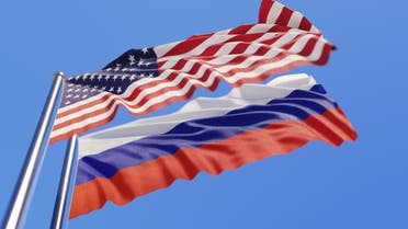 American And Russian Flags Waving With Wind On Blue Sky - Stock image