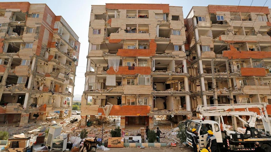Iranians salvage their furniture and household appliances as they bring them outside the damaged buildings in the town of Sarpol-e Zahab in the western Kermanshah province near the border with Iraq, on November 15, 2017, following a 7.3-magnitude earthquake. (AFP)