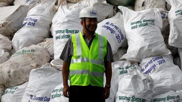 A man stands in front of the garbage collected and brought from Mount Everest to recycle in Kathmandu, Nepal June 5, 2019. (Reuters)