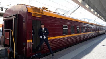 A train conductor steps down from a car of the first tourist train passing through Russia's Arctic regions to Norway as it prepares to leave Saint Petersburg for a 11-day trip with 91 passengers on board, June 5, 2019. (AFP)