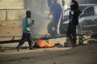 Locals set tires on fire and block a sidestreet leading to their neighborhood in the Sudanese capital Khartoum to stop military vehicles from driving through the area on June 4, 2019. (AFP)
