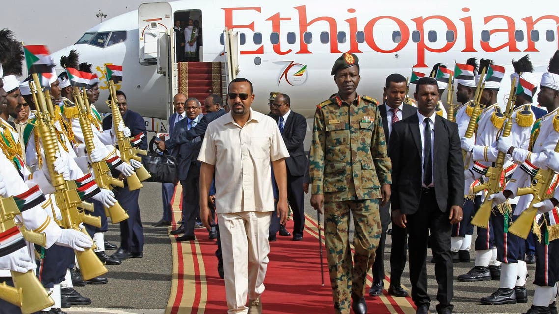 Ethiopia's Prime Minister Abiy Ahmed (C-L) walks alongside Shams-Eddin Kabashi Sudan's Transitional Military Council (TMC) spokesman (C-R) upon his arrival at Khartoum international airport on June 7, 2019 AFP